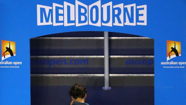 Roger Federer leaves the court after losing his Australian Open semi-final match against Rafael Nadal of Spain