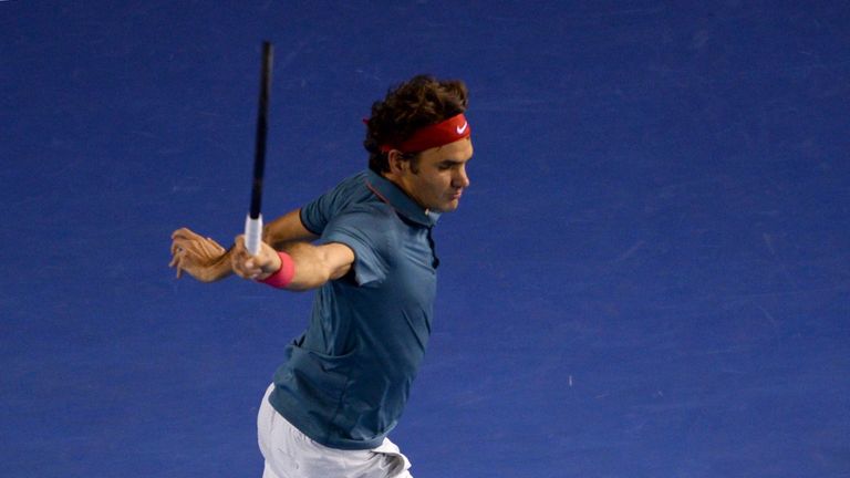 Roger Federer of Switzerland hits a return against Rafael Nadal of Spain during their men's singles semi-final match on day 12 of the 2014 Australian Open 
