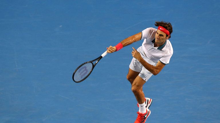 Roger Federer of Switzerland serves in his second round match against Blaz Kavcic of Slovenia during day four of the 2014 Australian Open