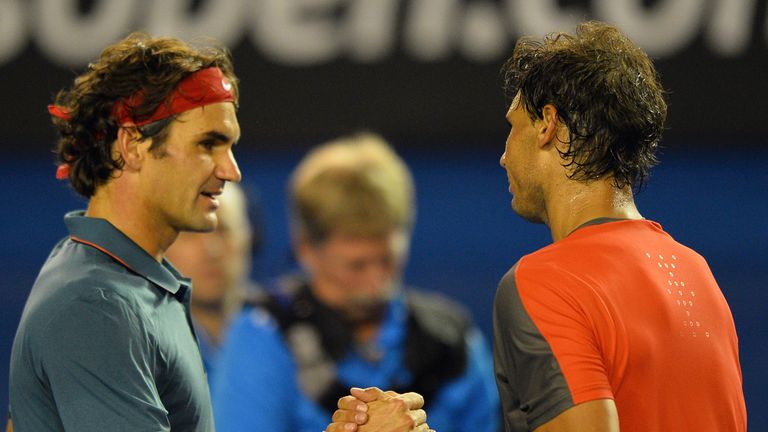 Spain's Rafael Nadal (R) shakes hands with Switzerland's Roger Federer after his victory during their men's singles semi-final match on day 12 of the 2014 