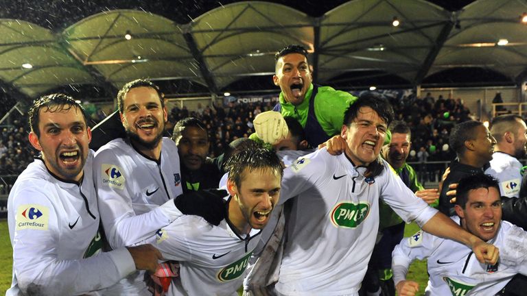 Yzeure's team members celebrate after their victory against Lorient after their French Cup football match at Bellevue Stadium in Yzeure, central France