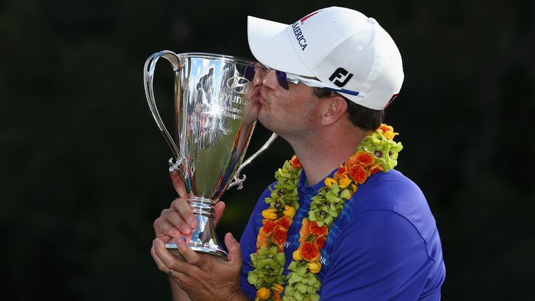 Zach Johnson kisses the trophy after winning the Hyundai Tournament of Champions at the Plantation Course at Kapalua Golf Club 