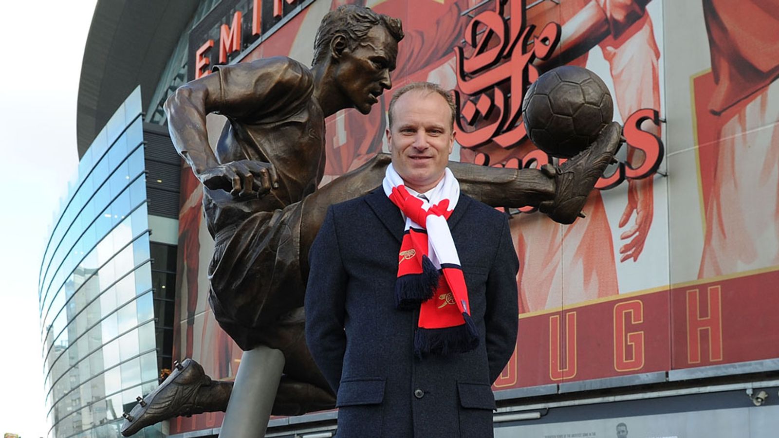  Dennis Bergkamp stands next to his statue outside Emirates Stadium.