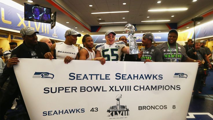 Linebacker Heath Farwell #55 of the Seattle Seahawks celebrates with teammates while holding the Vince Lombardi Trophy 