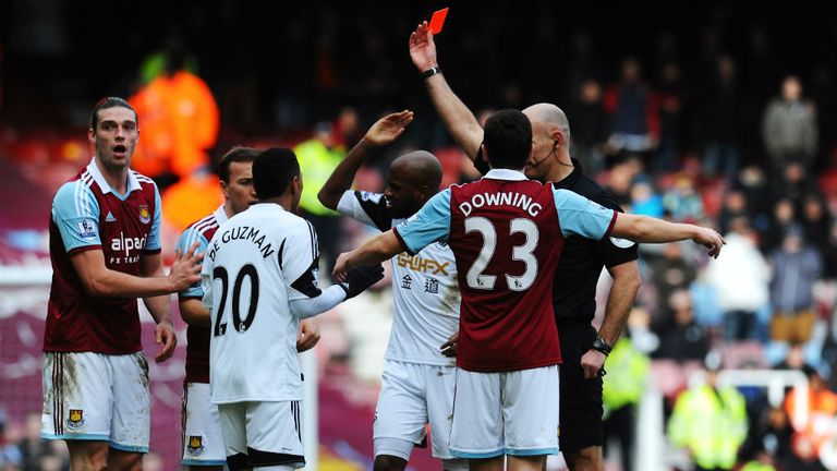 - Andy Carroll of West Ham United L is sent off by referee Howard Webb after a clash with Chico Flores of Swansea City R