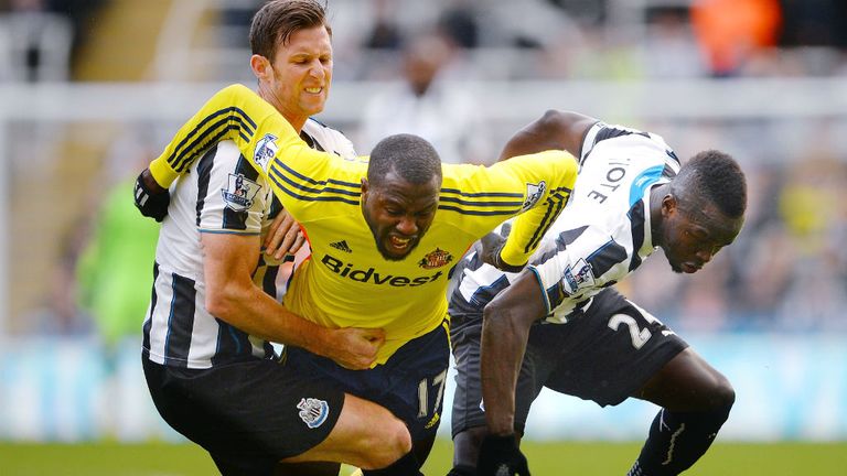 - Jozy Altidore of Sunderland is brought down by Michael Williamson L and Cheik Ismael Tiote R of Newcastle