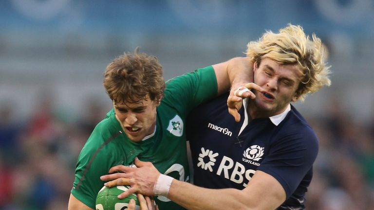 Andrew Trimble of Ireland holds off Richie Gray during the RBS Six Nations match between Ireland and Scotland 