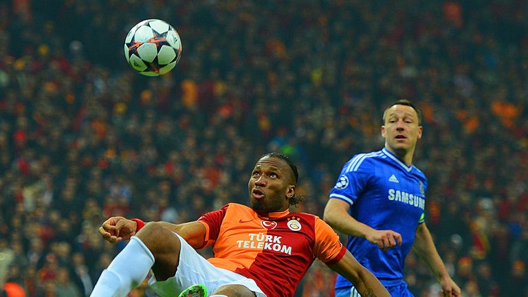 John Terry of Chelsea looks on as Didier Drogba of Galatasaray clears