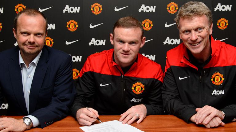 Wayne Rooney (C) of Manchester United poses with Manager David Moyes (R) and Executive Vice Chairman Ed Woodward after signing a contract extension