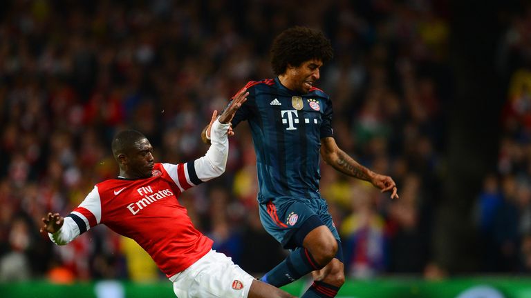 Yaya Sanogo tackles Dante for Arsenal against Bayern Munich