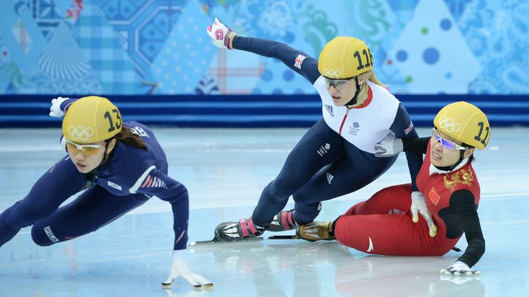 South Korea's Shim Suk Hee competes as Great Britain's Elise Christie and China's Li Jianrou collide in the women's short track 1000m semi-finals in Sochi 