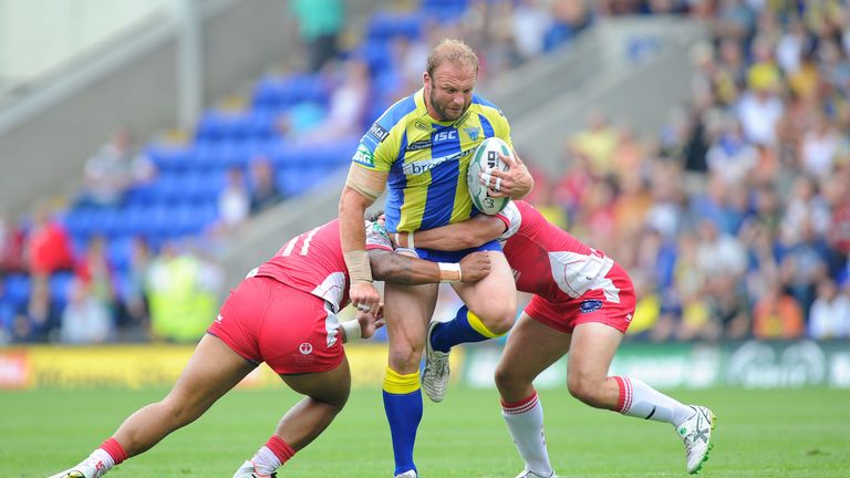 Warrington Wolves forward Garreth Carvell is tackled by Hull KR duo Constantine Mika (left) and Travis Burns