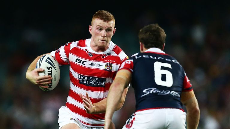 Jack Hughes of Wigan Warriors runs at James Maloney of the Roosters during the NRL World Club Challenge