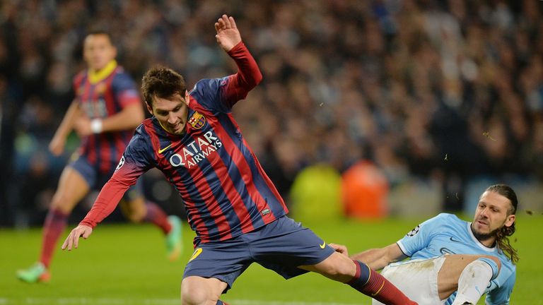 Manchester City's Martin Demichelis (R) fouls Barcelona's Lionel Messi