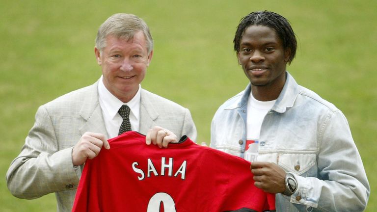 Manchester United new signing Louis Saha with manager Sir Alex Ferguson, shows off his new shirt at a press call at Old Trafford, Manchester. The deal was 