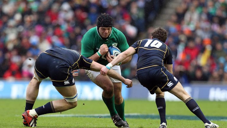 Ireland's prop Mike Ross (C) is tackled by Scotland's lock Richie Gray (L) and fly half Ruaridh Jackson (R) during the Six Nations international