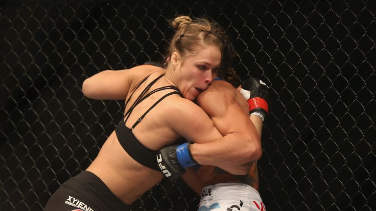 Ronda Rousey pins Liz Carmouche up against the fence in their UFC Bantamweight Title fight