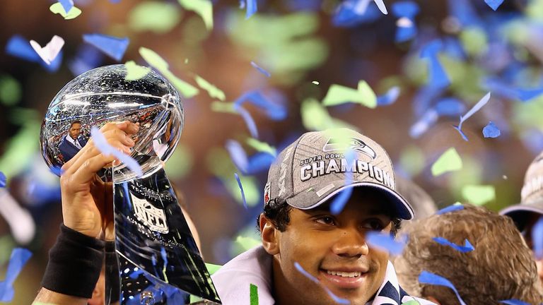 Russell Wilson of the Seattle Seahawks holds the Vince Lombardi Trophy after winning Super Bowl XLVIII