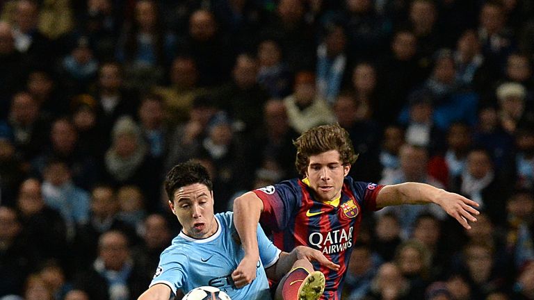 Manchester City's Samir Nasri (left) and Barcelona's Carnicer Sergi Roberto battle for the ball
