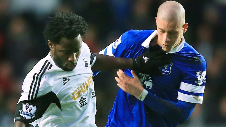 SWANSEA, WALES - DECEMBER 22:  Wilfried Bony of Swansea holds off the challenge from Ross Barkley of Everton during the Barclays Premier League match betwe