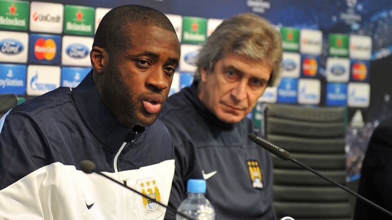 Manchester City's Ivorian midfielder Yaya Toure (L) and Manchester City's Chilean manager Manuel Pellegrini address the media at a press conference at The 
