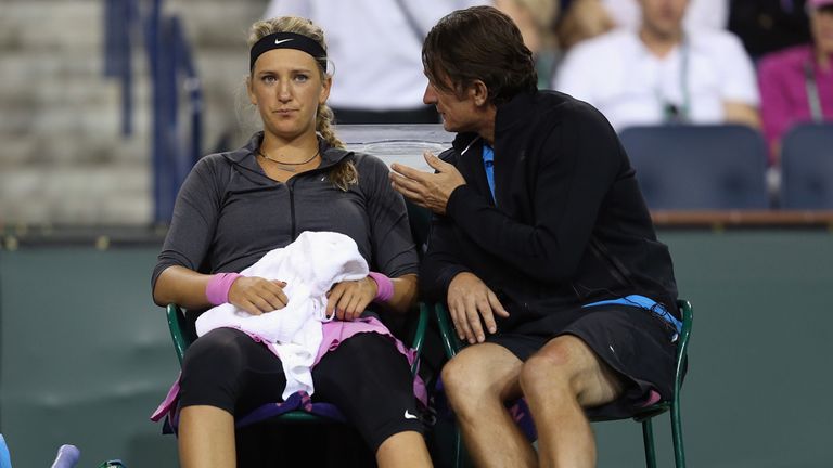 talks to her coach after losing the first set to Lauren Davis during the BNP Paribas Open at Indian Wells