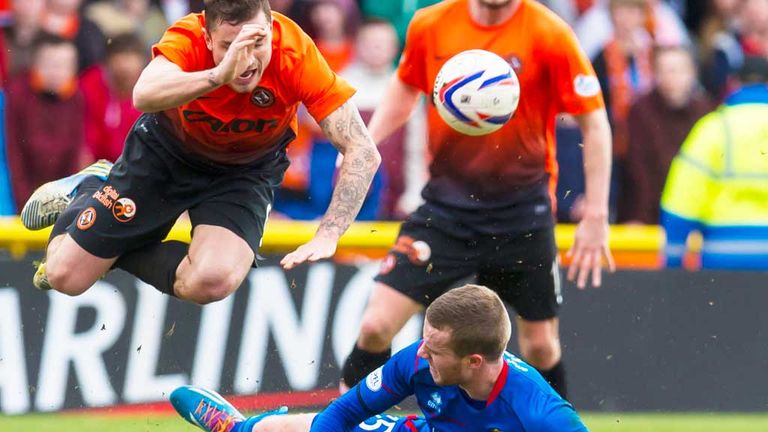 Inverness Caley's Marley Watkins (grounded) fouls Dundee United's Paul Paton