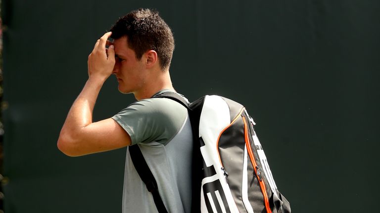 Bernard Tomic of Australia leaves the court after losing to Jarkko Nieminen of Finland during the Sony Open