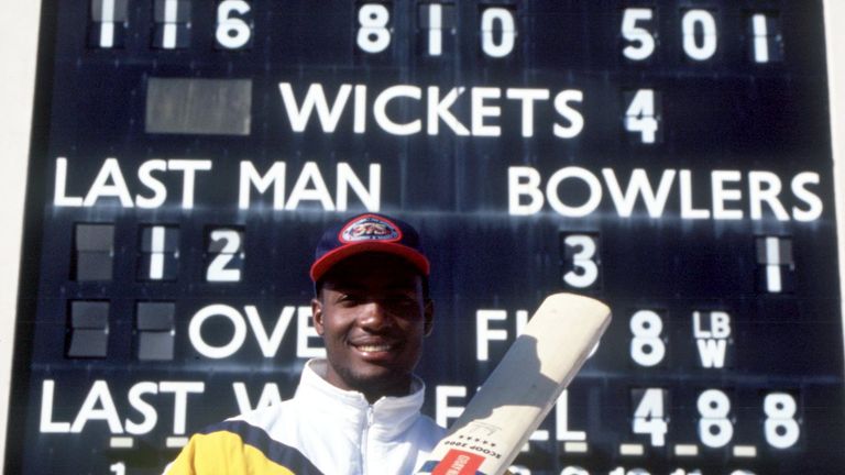 Brian Lara poses in front of the scoreboard at Edgbaston after breaking the world record by making 501 not out for Warwickshire