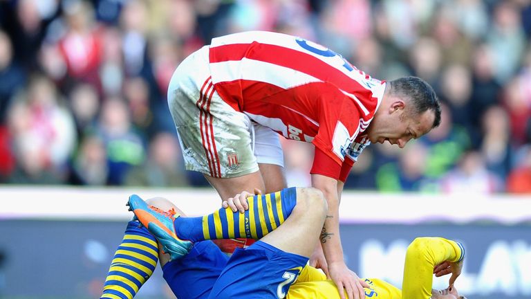 Olivier Giroud of Arsenal is consoled by Charlie Adam of Stoke City