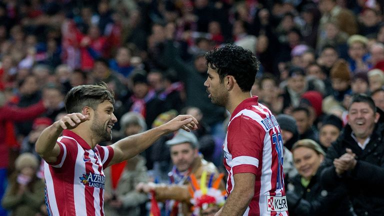 MADRID, SPAIN - FEBRUARY 02: Diego Costa (R) of Atletico de Madrid celebrates scoring their second goal with teammate Diego Ribas (L)