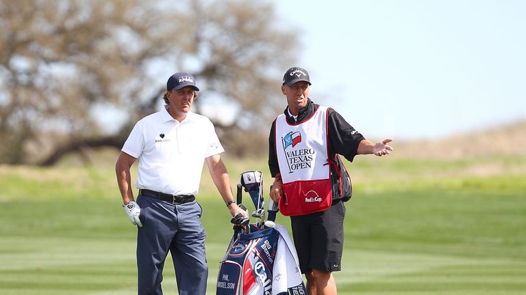 Phil Mickelson with caddie Jim Mackay before pulling out in round three