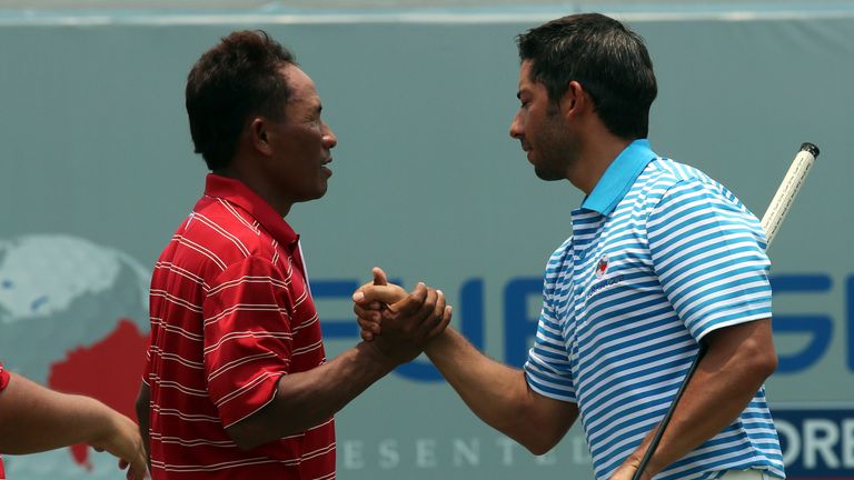 Thongchai Jaidee of Team Asia shakes hand with Pablo Larrazabal of Team Europe on the 18th hole after their foursomes match