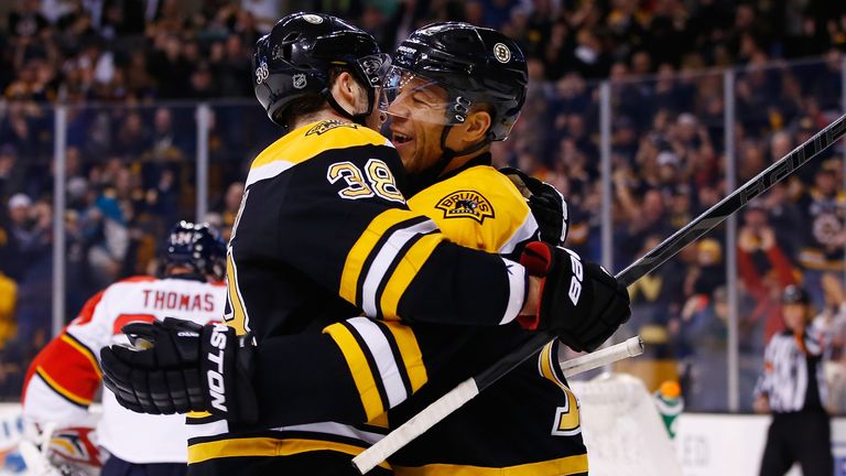 Jarome Iginla #12 of the Boston Bruins celebrates with teammate Jordan Caron #38 following his goal in the first period