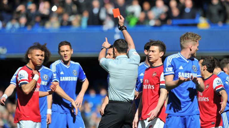 Kieran Gibbs (L) is sent off by referee Andre Marriner (C) during the Premier League match between Chelsea and Arsenal