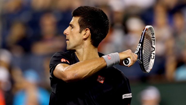 Novak Djokovic returns a shot to Victor Hanescu during the BNP Parabas Open in Indian Wells