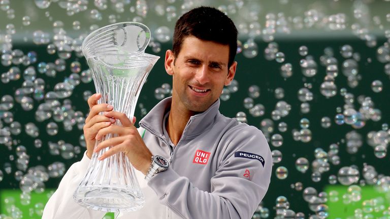 Novak Djokovic poses for photographers with the Butch Buchholz Torphy after defeating Rafael Nadal to win the Sony Open Tennis