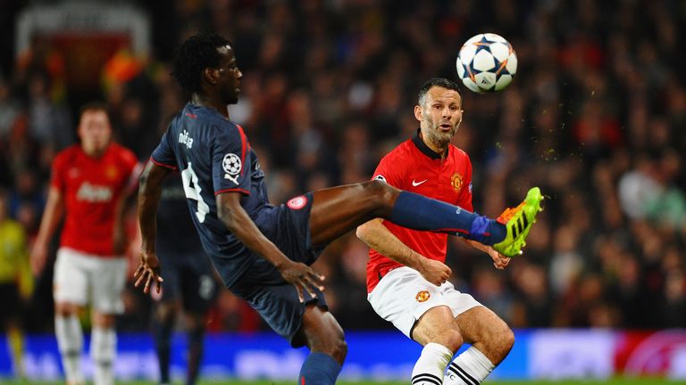 Ryan Giggs of Manchester United competes with Delvin N'Dinga of Olympiacos