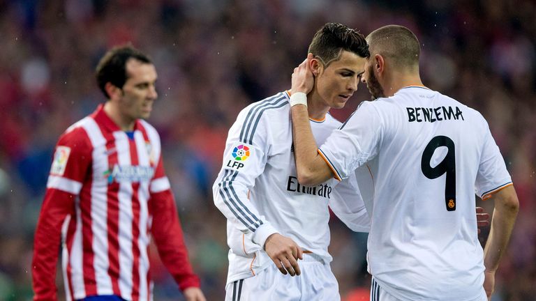 MADRID, SPAIN - MARCH 02:  Karim Benzema (2ndR) embraces his teammate Cristiano Ronaldo (R) as Diego Godin (L) of Atletico de Madrid reacts defeated during
