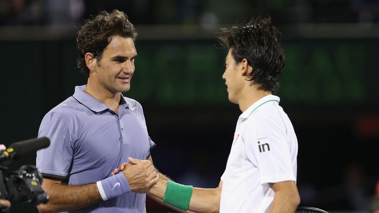 Roger Federer shakes hands at the net after his three set defeat by Kei Nishikori during their quarter-final at the  Sony Open