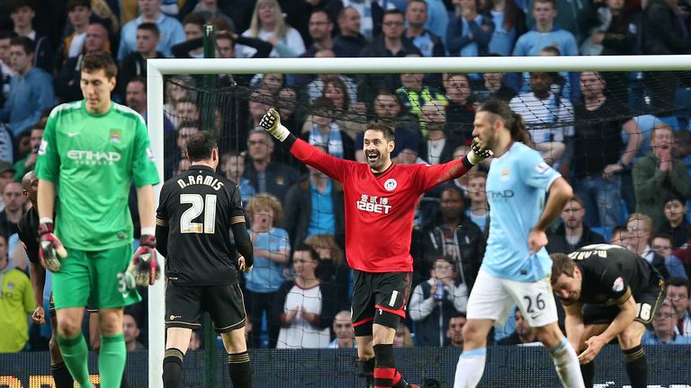 Wigan goalkeeper Scott Carson celebrates their win over Manchester City