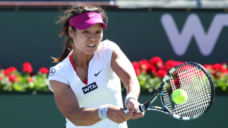 Li Na of China hits a return to Zheng Jie of China during the BNP Paribas Open at Indian Wells Tennis Garden on March 8, 2014