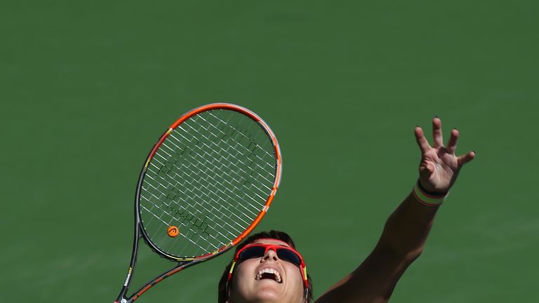 Yaroslava Shvedova of Kazakhstan serves to Caroline Wozniacki of Denmark during the BNP Paribas Open at Indian Wells