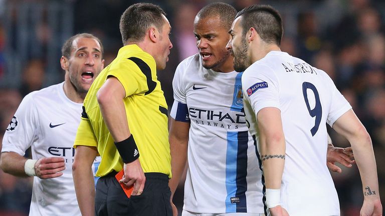 Vincent Kompany of Manchester City argues with referee Stephane Lannoy after Pablo Zabaleta is sent off