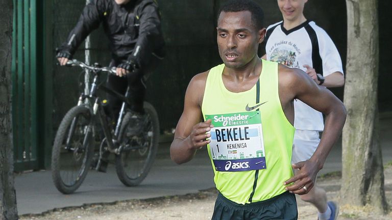 kenenisa bekele trotting through the streets of paris on sunday