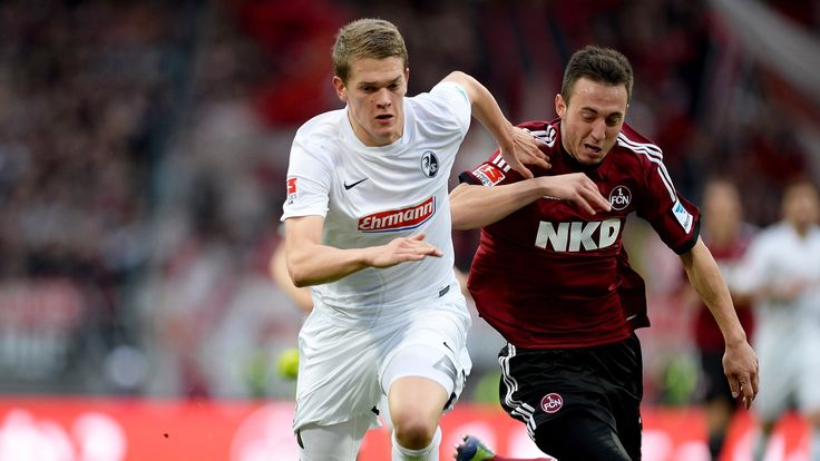 NUREMBERG, GERMANY - NOVEMBER 02:  Matthias Ginter of Freiburg and Josip Drmic (R) of Nuernberg compete for the ball during the Bundesliga match between 1.
