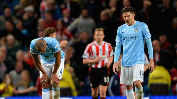 MANCHESTER, ENGLAND - APRIL 16:  A dejected Vincent Kompany and Javi Garcia of Manchester City during the Barclays Premier League match between Manchester 