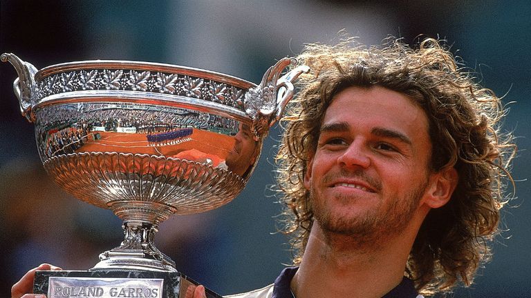 - Gustavo Kuerten of Brazil poses with the trophy after winning the mens singles final match against Magnus Norman of Sweden at the French Open at Roland Garros