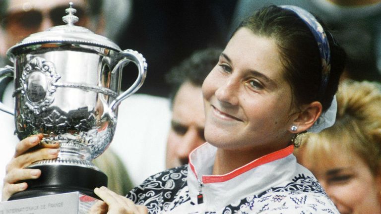 - Yugoslavian tennis player Monica Seles is all smiles as she holds up the winners cup after defeating Germanys Steffi Graf in three sets