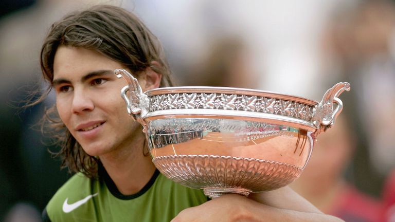 - Rafael Nadal of Spain poses with the winners trophy after his 3-1 sets victory over Mariano Puerta of Argentina during the Mens Final 2005